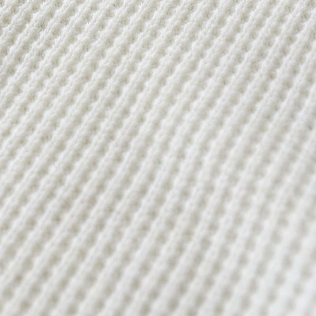 White waffle-knit fabric supporting detail, hardware excluded