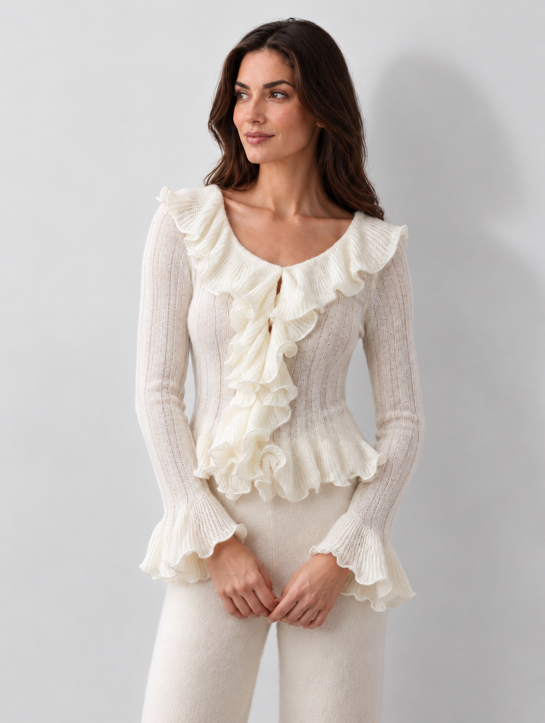 Cream ruffle knit top, W02 relaxed front angle showing bell cuffs and ruffled hem