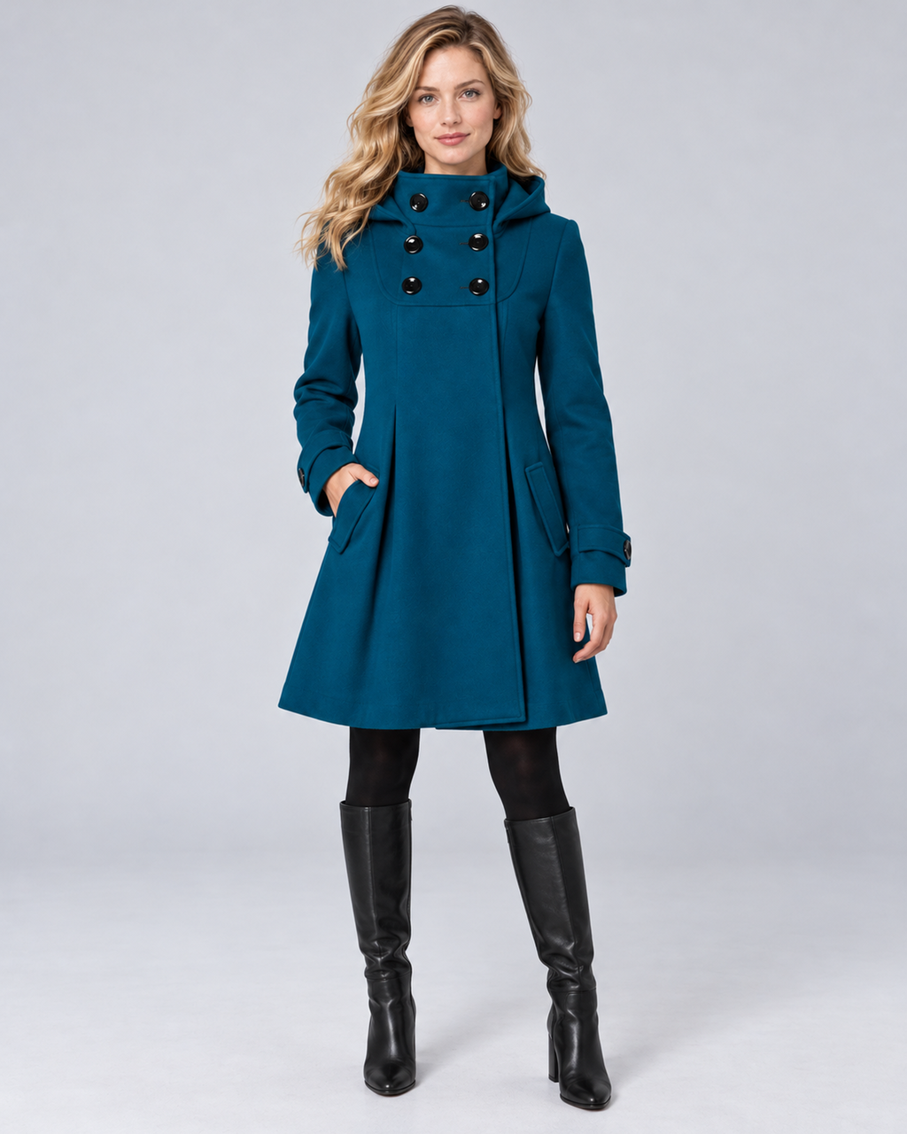 Women's hooded high-neck A-line coat in teal, front hero, on the approved studio model
