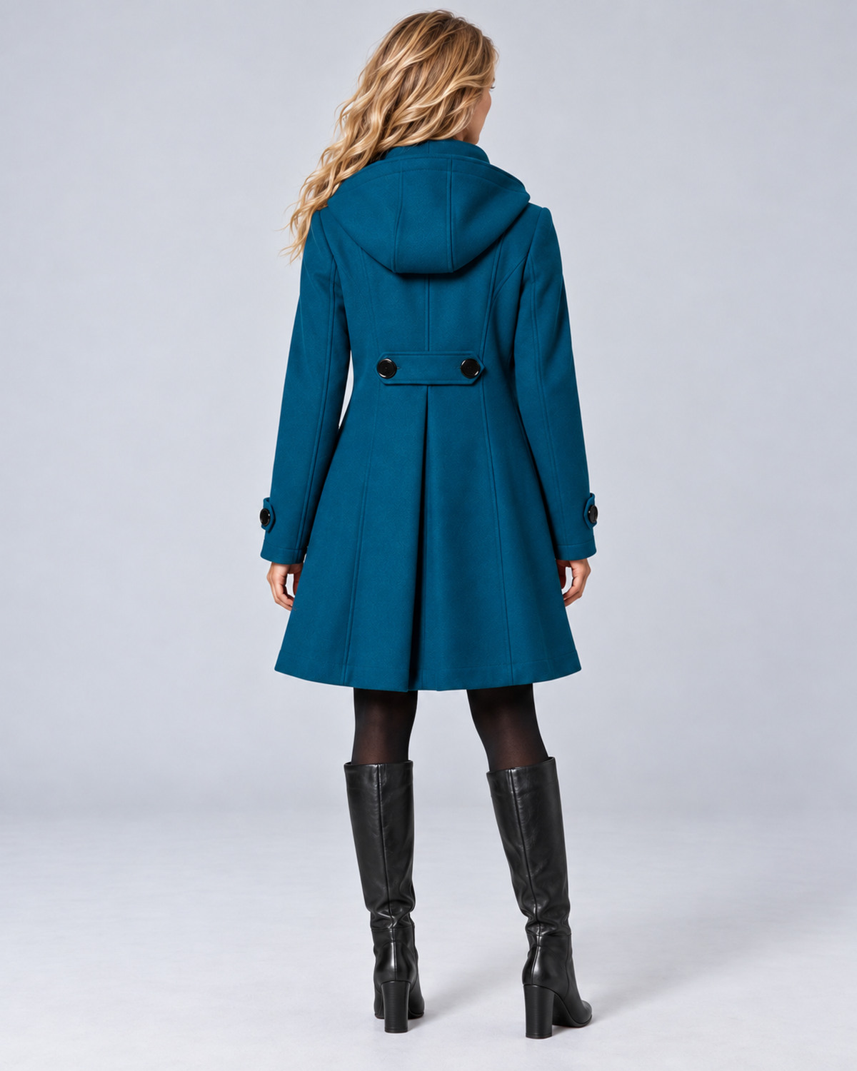 Women's hooded high-neck A-line coat in teal, rear full-length, on the approved studio model