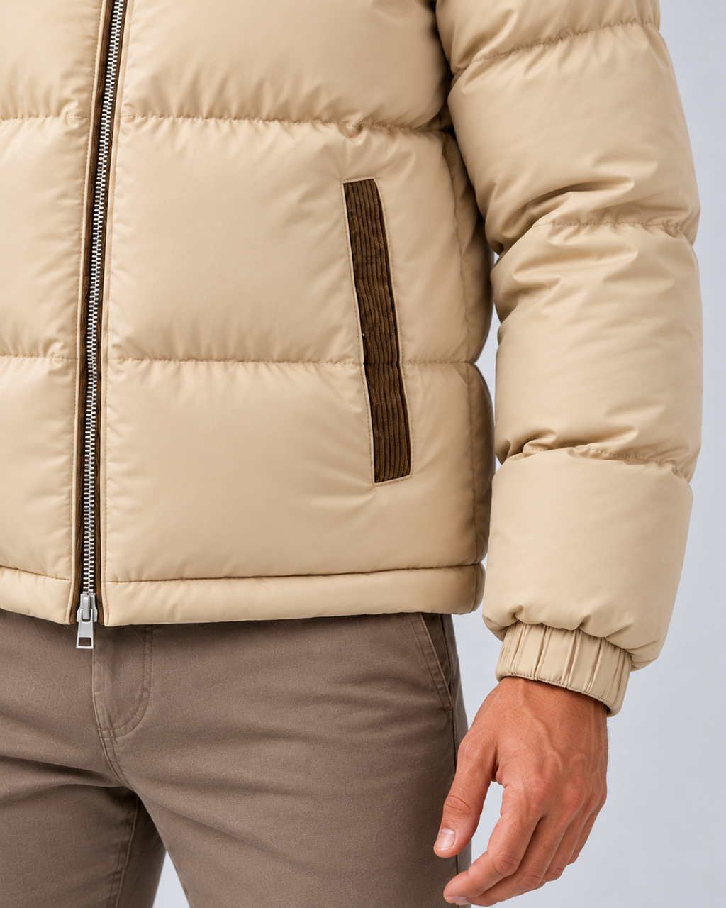 Men's hooded quilted puffer jacket in beige, pocket and cuff detail, photographed on the approved studio model