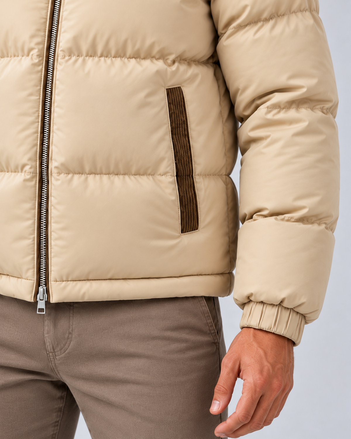 Men's hooded quilted puffer jacket in beige, pocket and cuff detail, photographed on the approved studio model