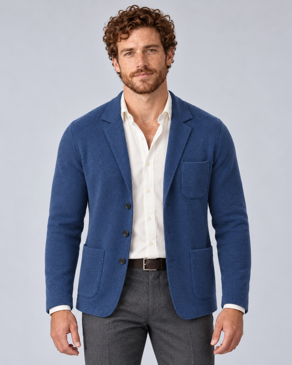 Men's knit blazer jacket in blue, front hero, photographed in a grey studio