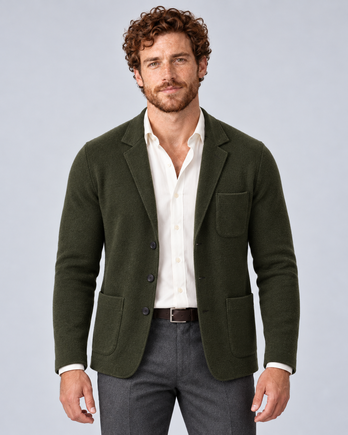 Men's knit blazer jacket in dark green, front hero, photographed in a grey studio