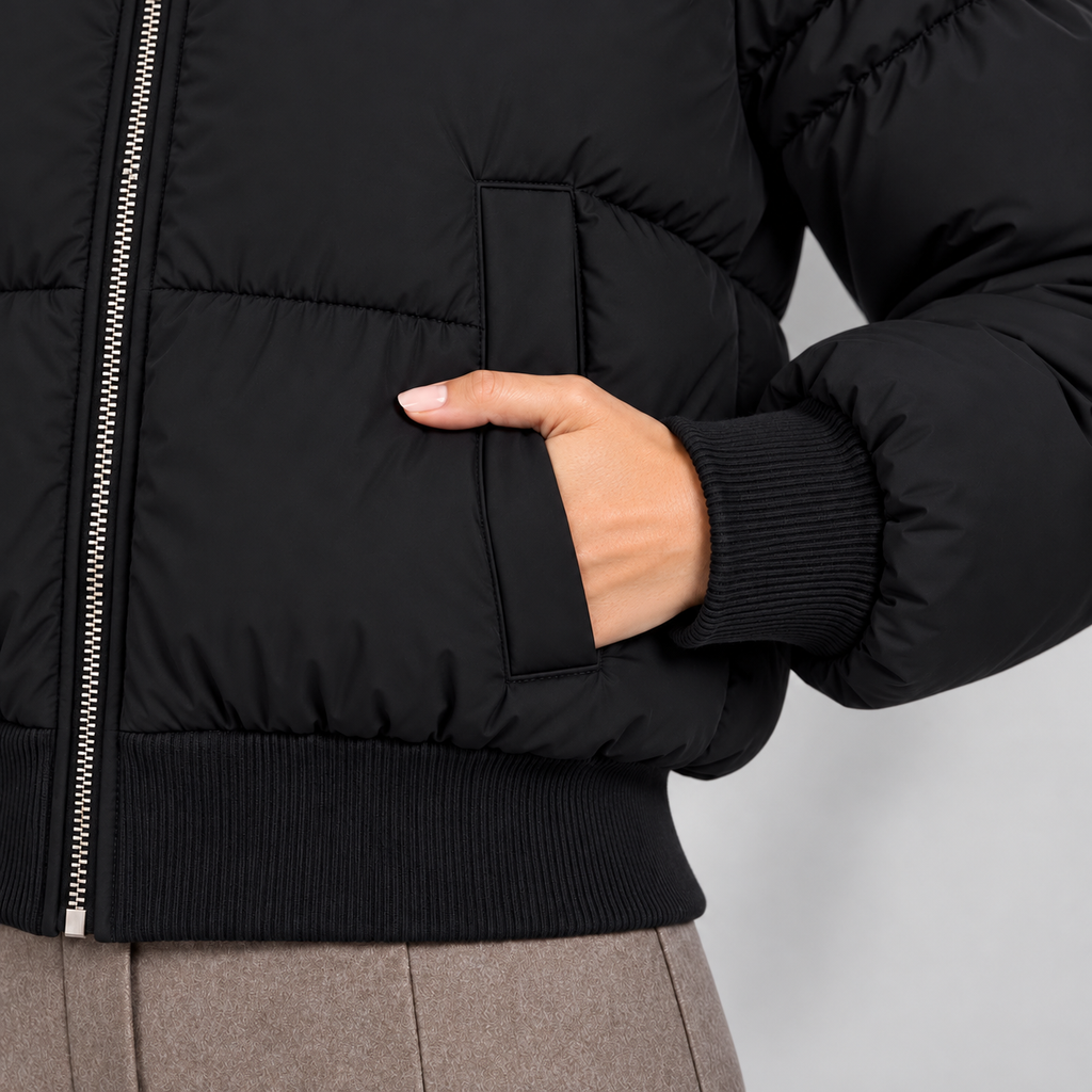 Women's cropped puffer jacket in black, pocket view on Avery Mercer model W01
