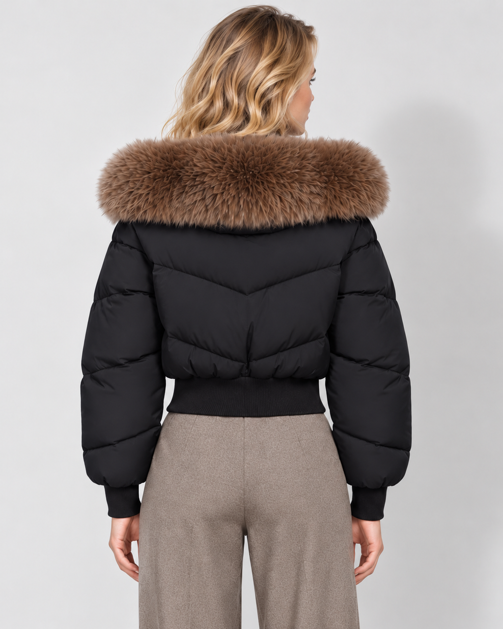Women's cropped puffer jacket in black, rear view on Avery Mercer model W01
