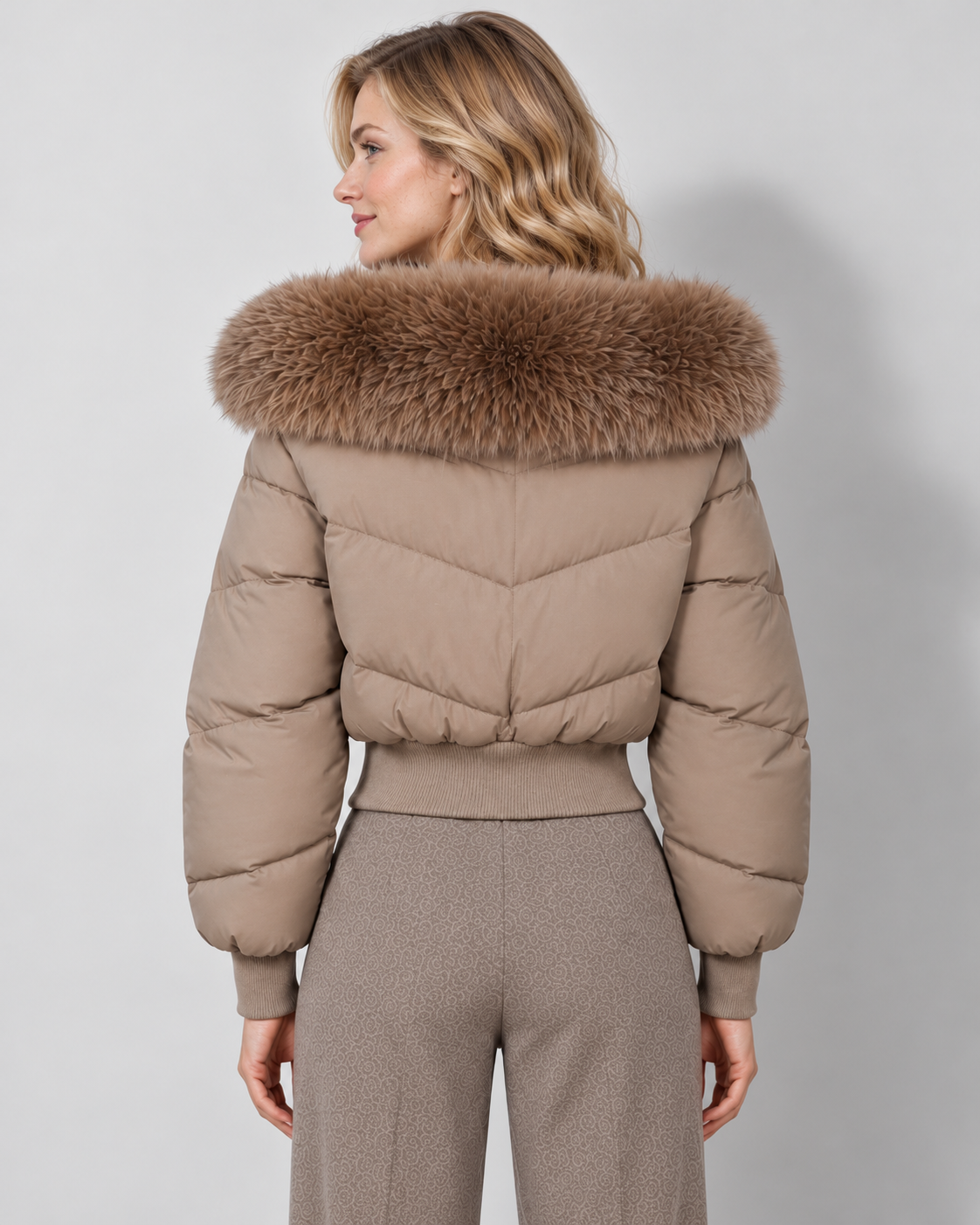 Women's cropped puffer jacket in camel, rear view on Avery Mercer model W01