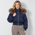 Women's cropped puffer jacket in navy, front view on Avery Mercer model W01
