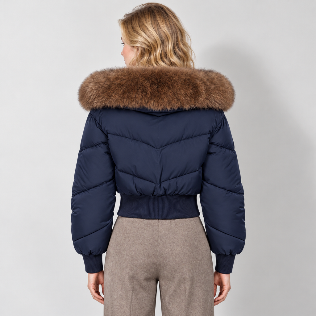 Women's cropped puffer jacket in navy, rear view on Avery Mercer model W01