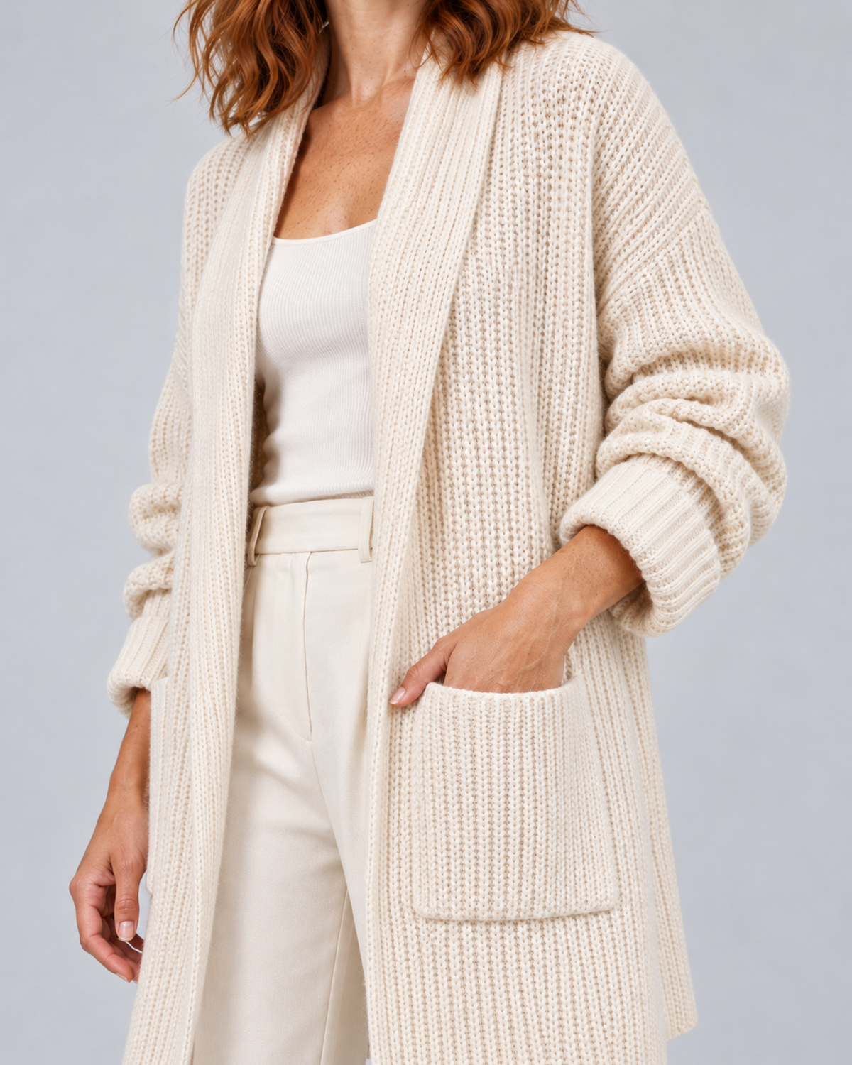 Women's longline open-front knit cardigan in beige, pocket and cuff detail, on approved studio model