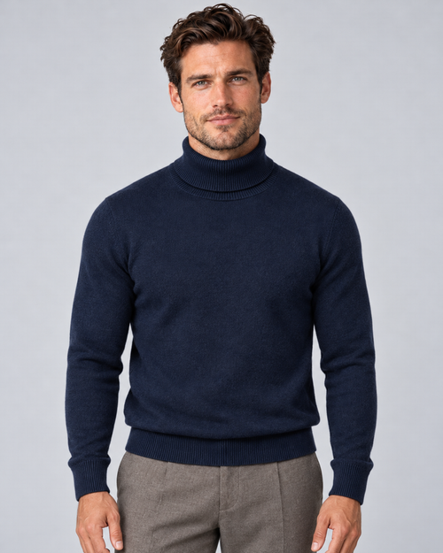Men's fine-knit turtleneck sweater in navy, front hero, on a male model in a light grey studio
