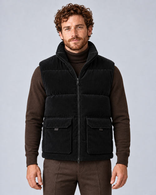 Men's corduroy puffer gilet in black, front hero, on studio model