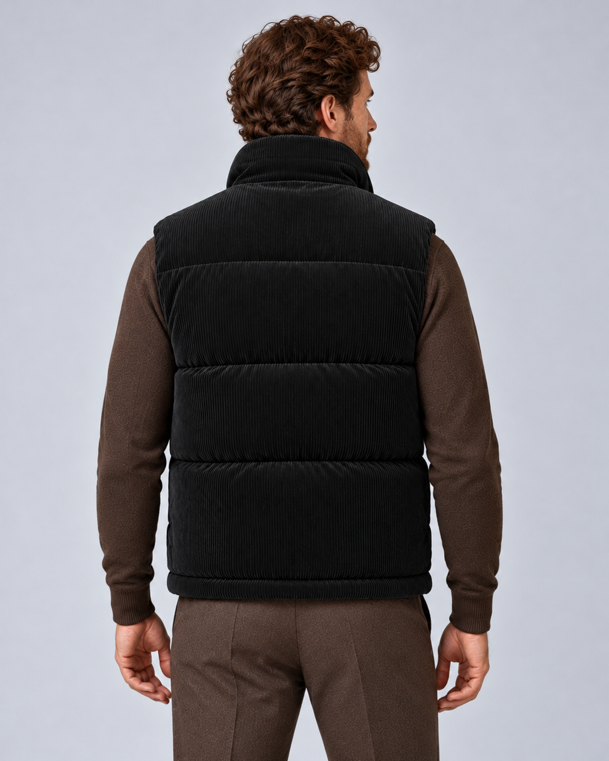 Men's corduroy puffer gilet in black, rear view, on studio model