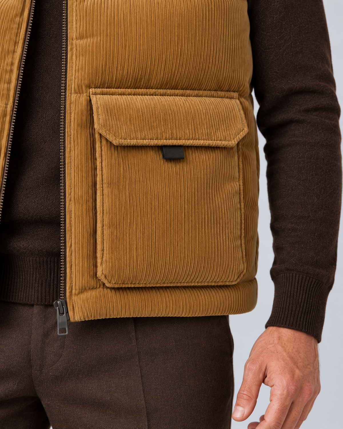 Men's corduroy puffer gilet in khaki, pocket and corduroy detail, on studio model