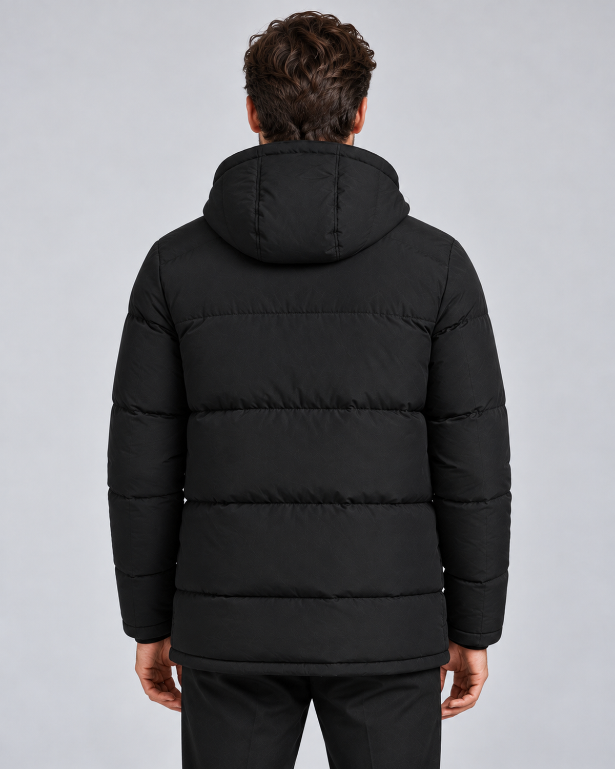 Men's hooded puffer jacket in black, rear view, on approved studio model