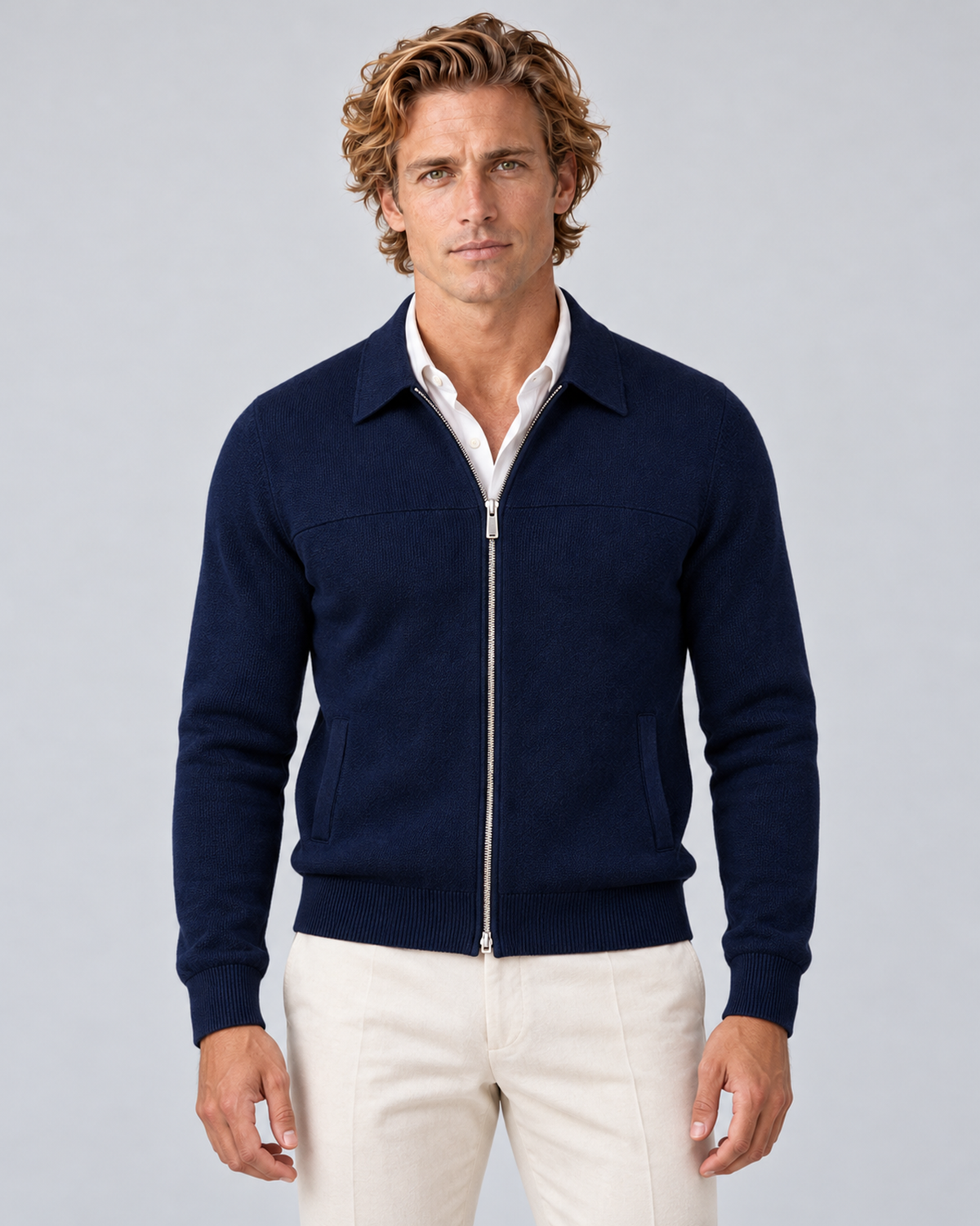 Men's full-zip collared knit jumper in navy blue, front hero, photographed in a grey studio