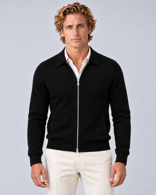 Men's full-zip collared knit jumper in black, front hero, photographed in a grey studio