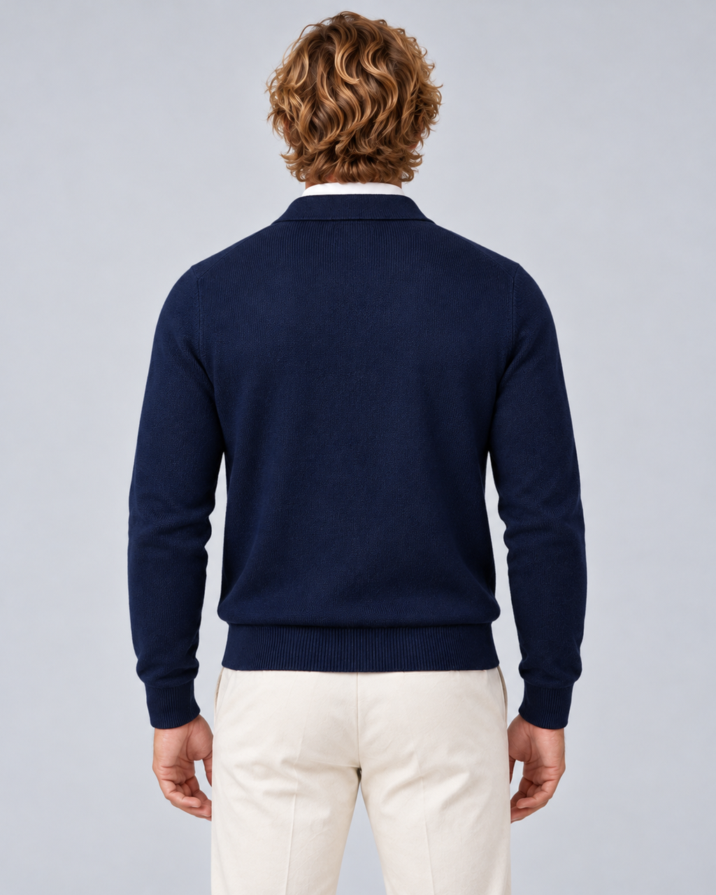 Men's full-zip collared knit jumper in navy blue, rear, photographed in a grey studio