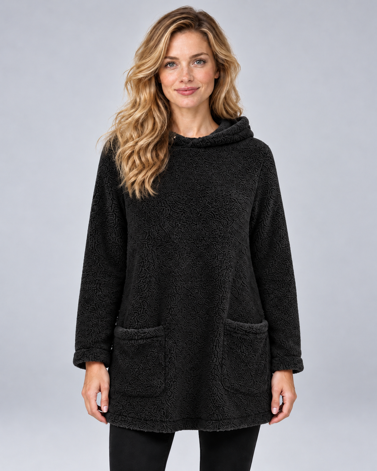 Women's plush hooded tunic in black, front hero, photographed in a grey studio