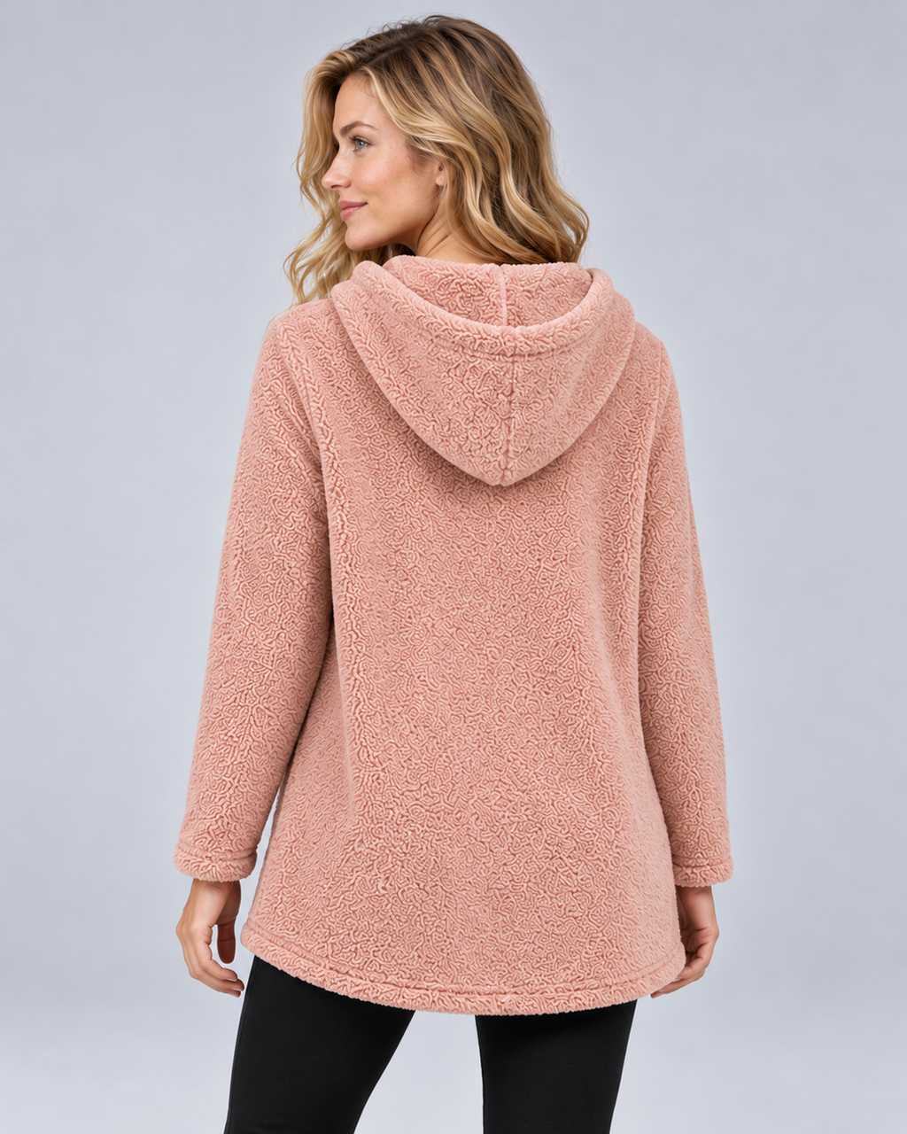Women's plush hooded tunic in pink, rear three-quarter view, photographed in a grey studio
