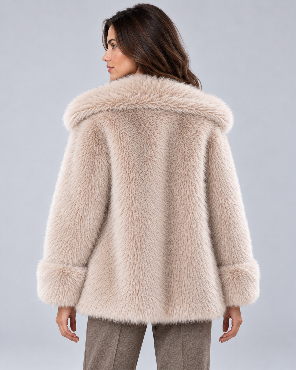 Women's short faux fur coat in khaki, rear view, photographed on a model in a grey studio