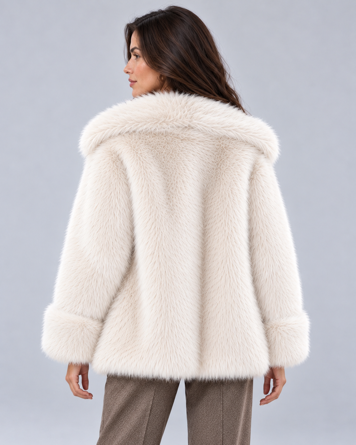 Women's short faux fur coat in white, rear view, photographed on a model in a grey studio