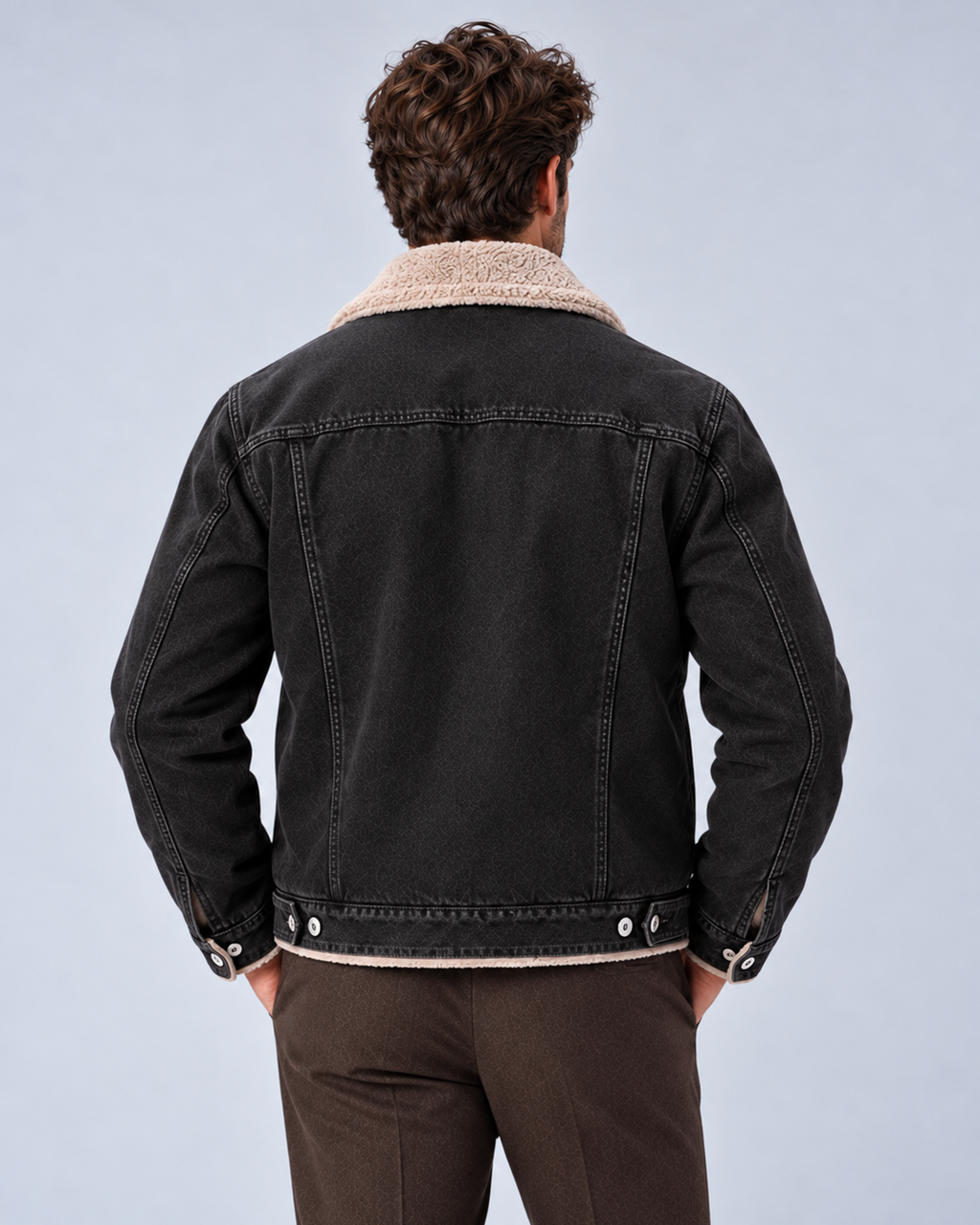 Men’s sherpa-lined denim trucker jacket in black, rear view, on studio model