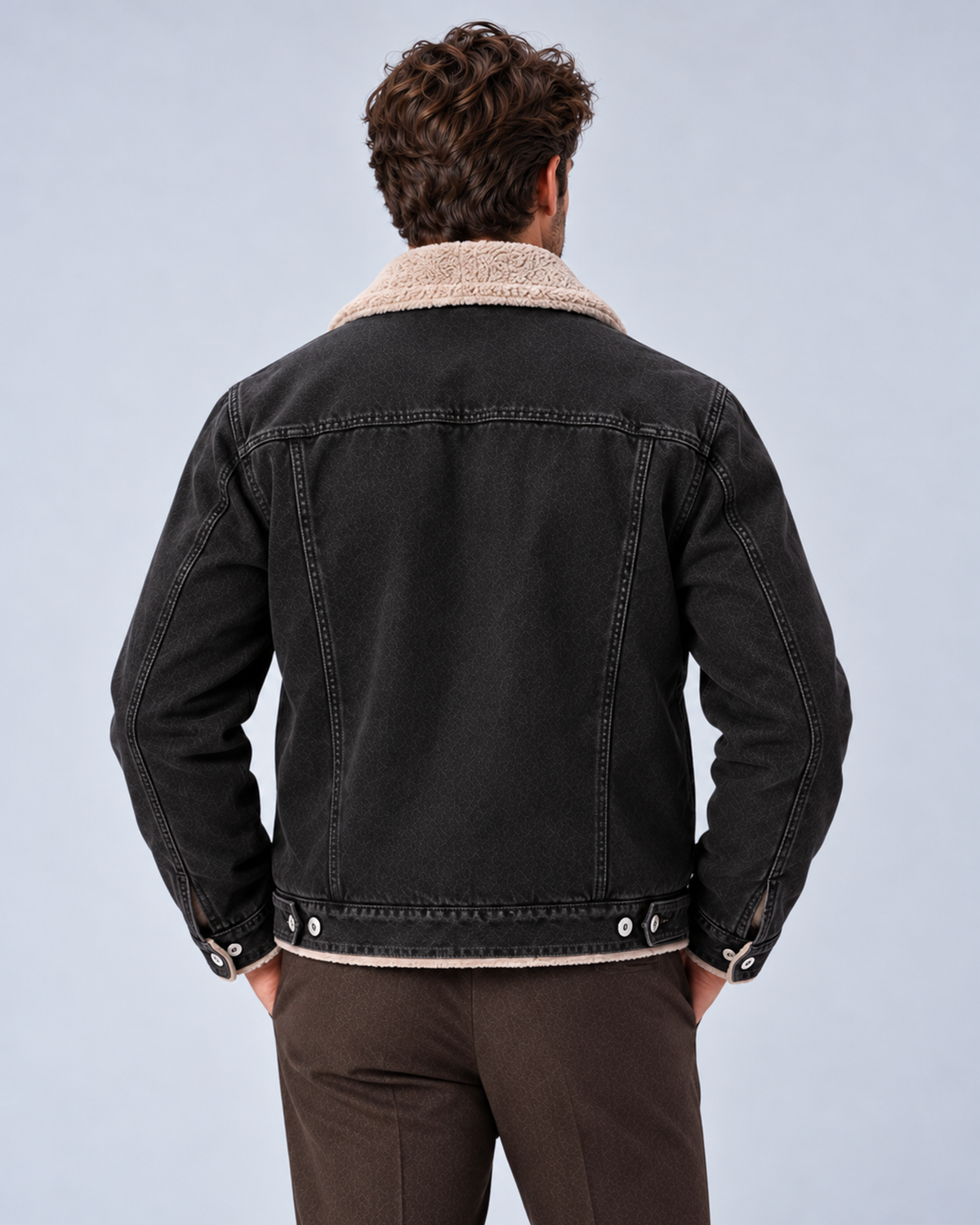 Men’s sherpa-lined denim trucker jacket in black, rear view, on studio model