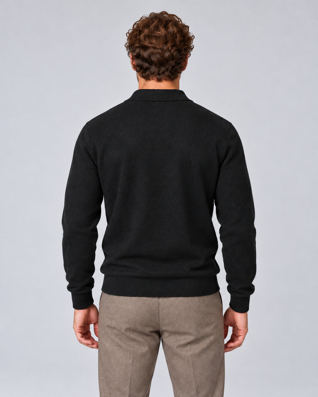 Men’s black textured long-sleeve polo sweater, back view on model.