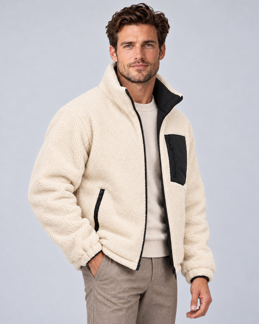 Black reversible jacket worn with ivory sherpa side out, front three-quarter view