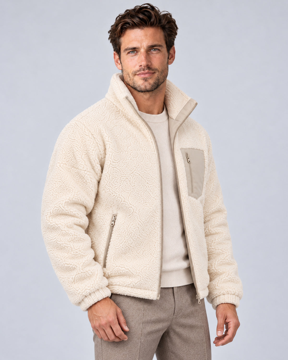 Khaki reversible jacket worn with ivory sherpa side out, front three-quarter view
