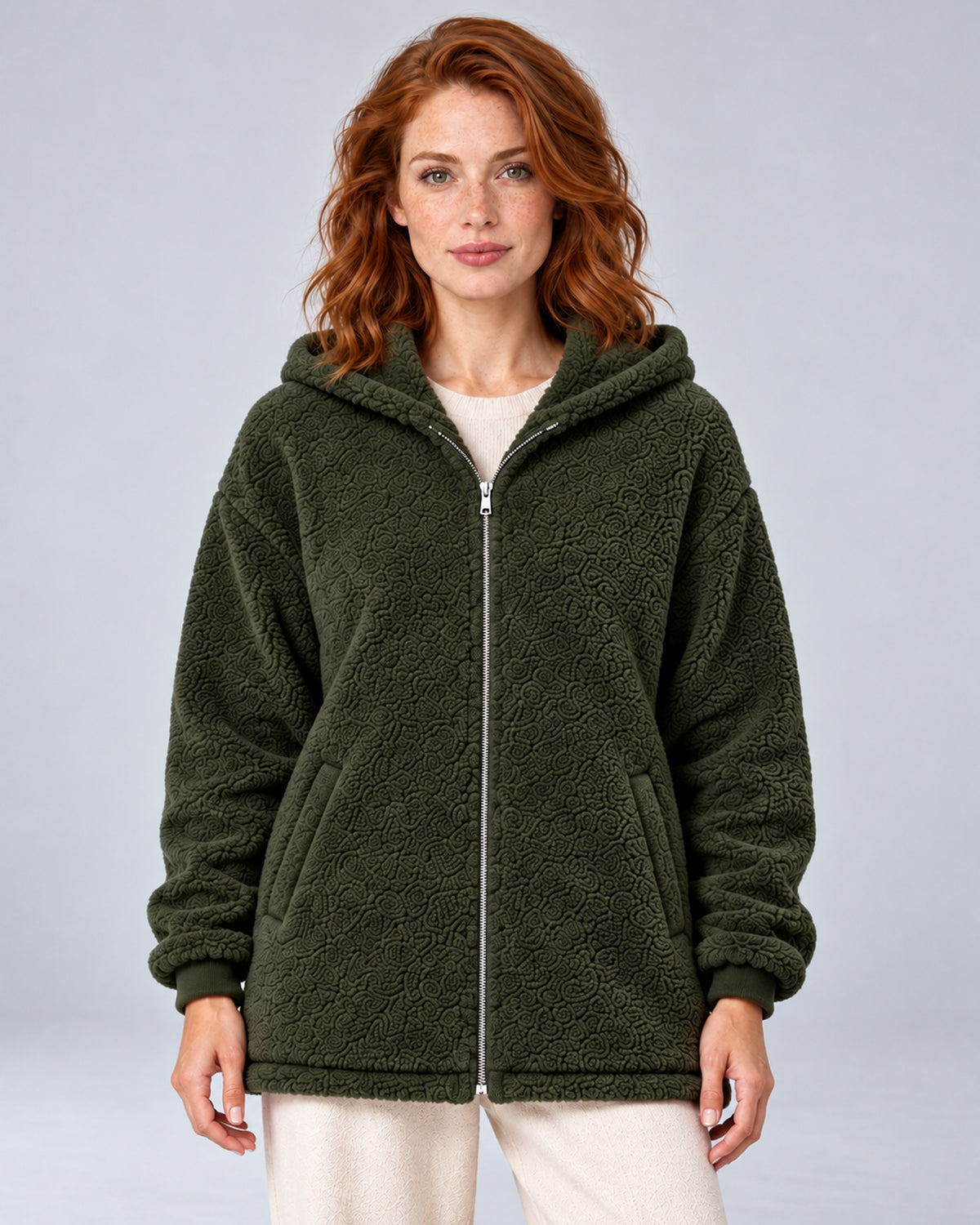 Women's green hooded teddy fleece zip-up cardigan, front view on model.
