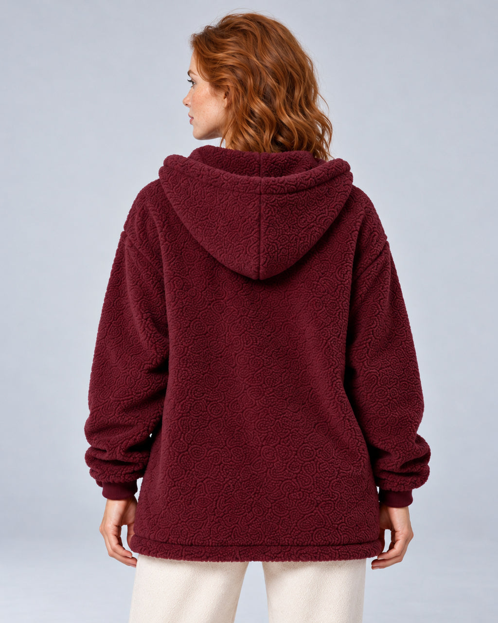 Women's burgundy hooded teddy fleece zip-up cardigan, rear on model.