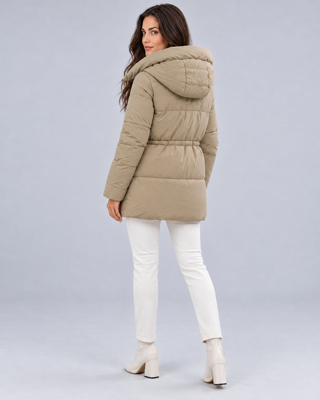 Women’s khaki padded hooded parka, rear three-quarter view on model.