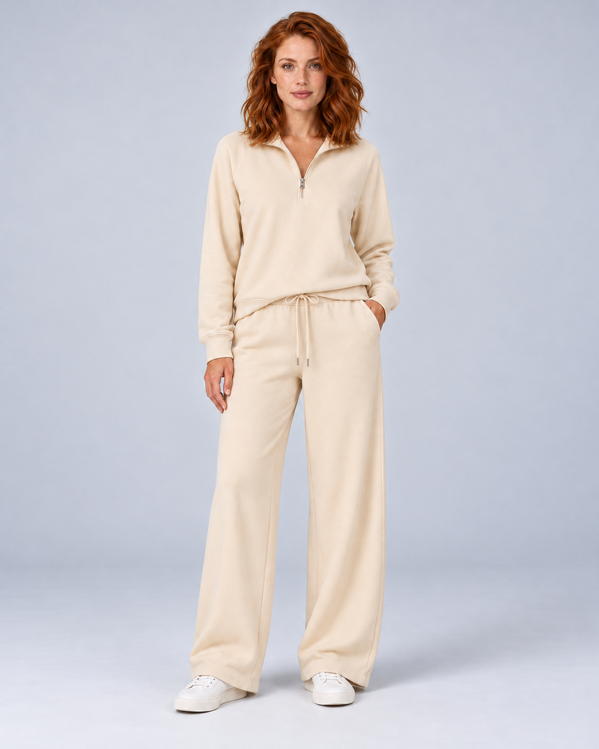 Women's cream two-piece lounge set with a half-zip stand-collar top and wide-leg trousers, front view.