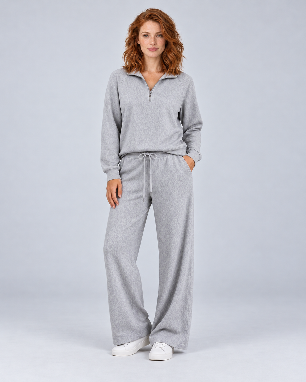 Women's light grey two-piece lounge set with a half-zip stand-collar top and wide-leg trousers, front view.