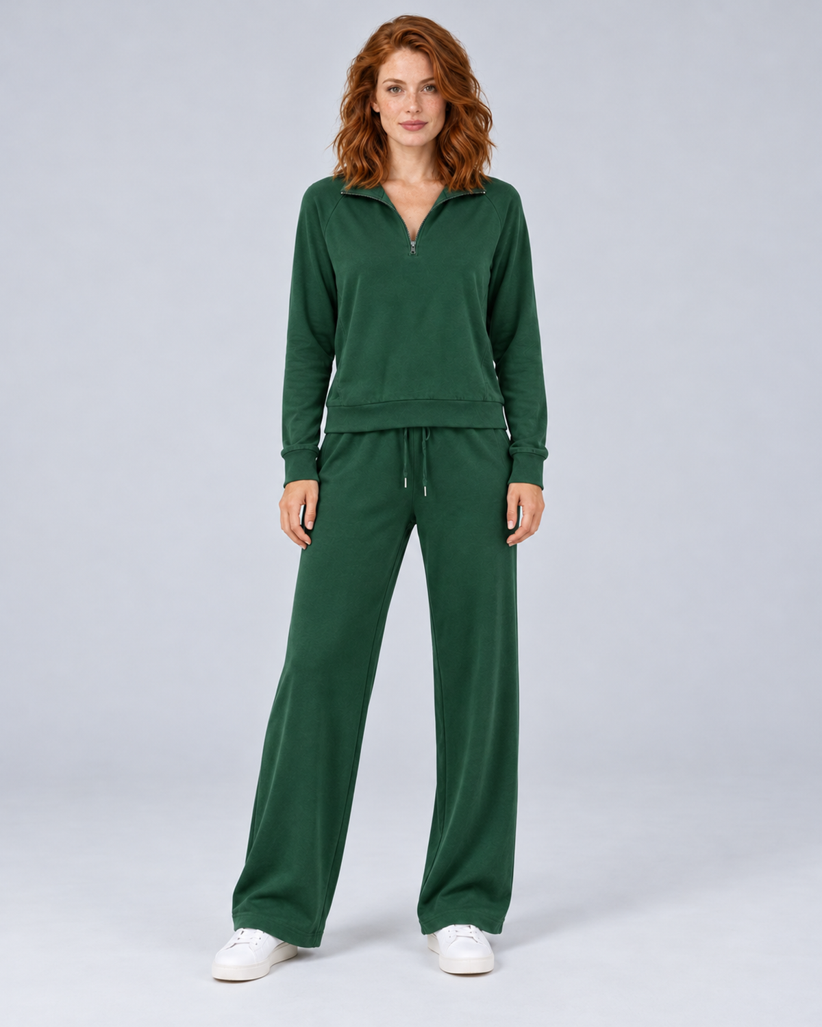 Women's dark green two-piece lounge set with a half-zip stand-collar top and wide-leg trousers, front view.