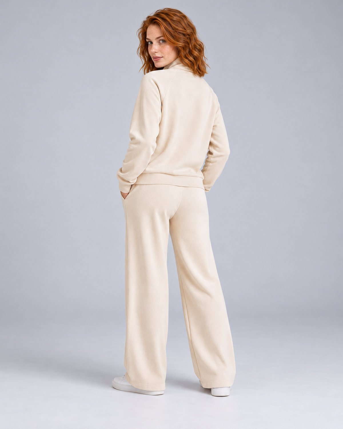 Women's cream two-piece lounge set with a half-zip stand-collar top and wide-leg trousers, rear three-quarter view.