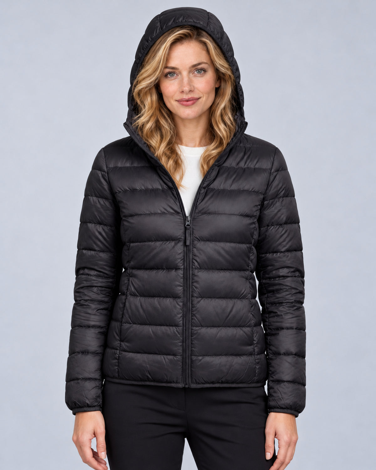 Black women's hooded quilted puffer jacket, front view with hood up
