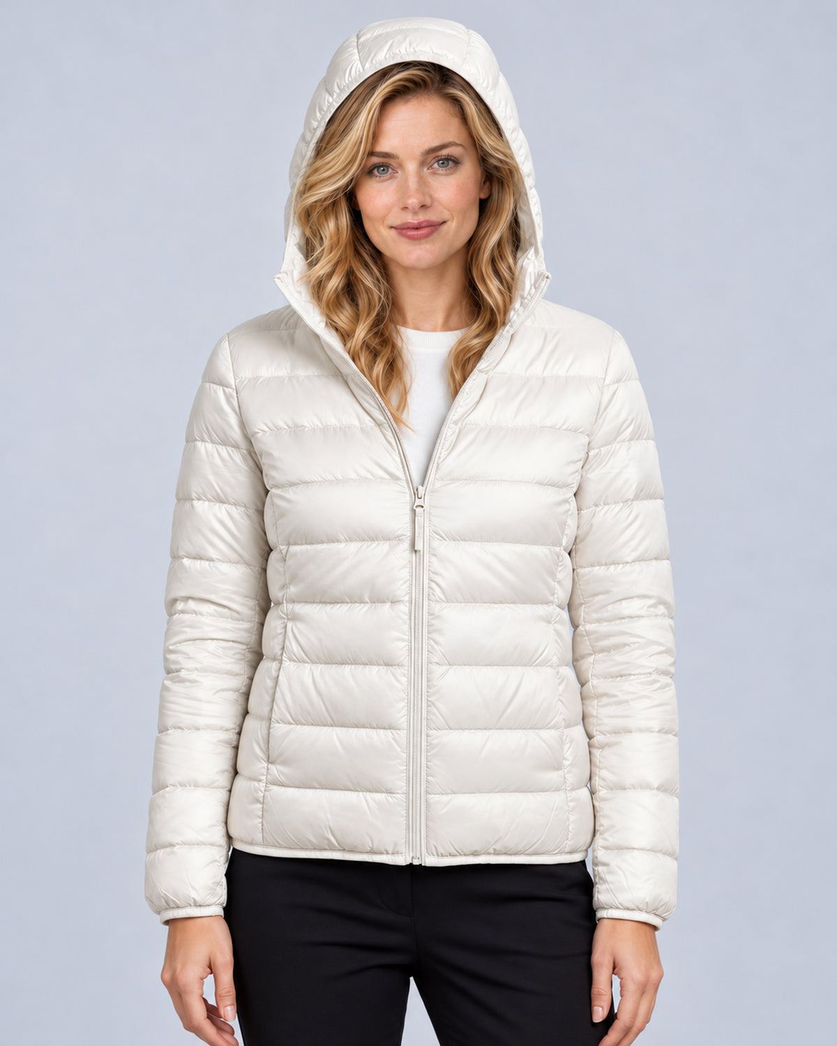 White women's hooded quilted puffer jacket, front view with hood up