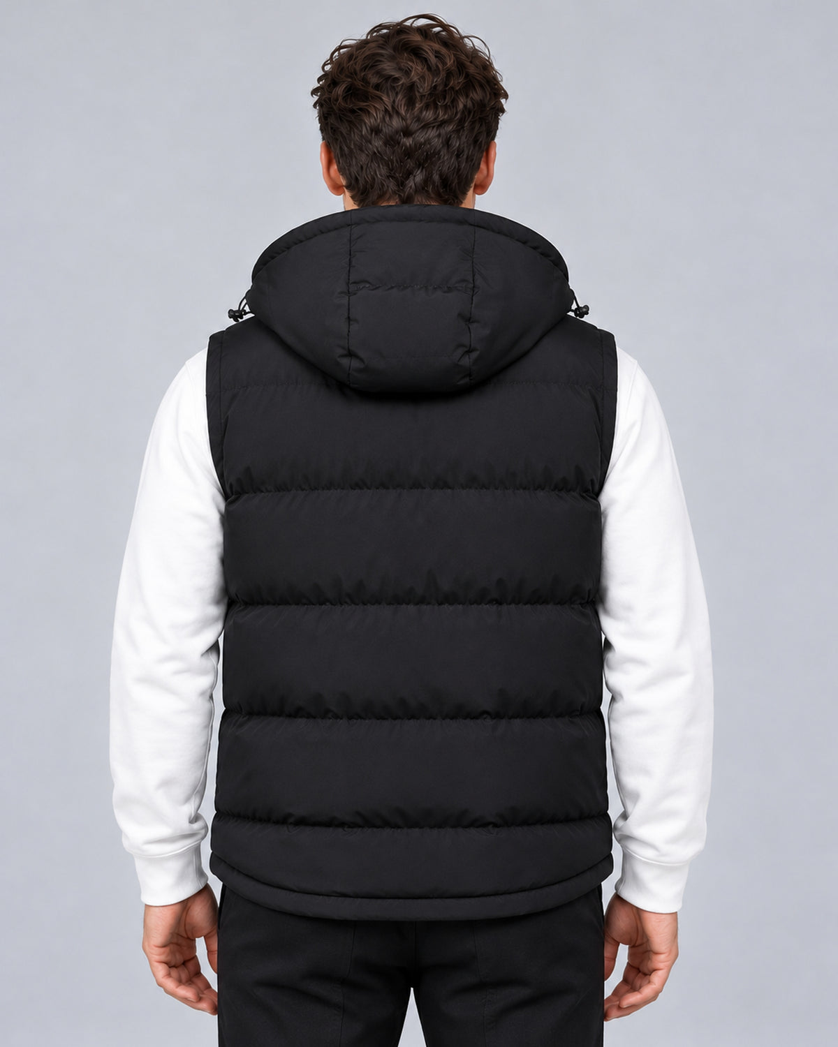 Men's black hooded padded gilet with horizontal quilting, rear view on a model.