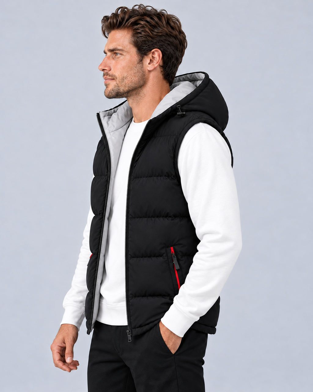 Men's black hooded padded gilet with horizontal quilting, side view on a model.