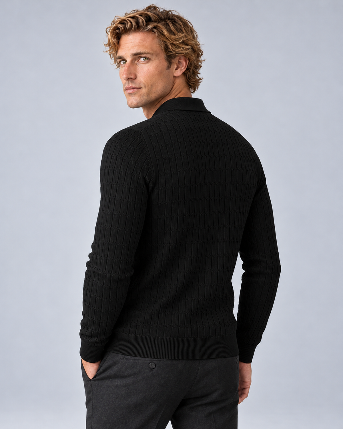 Rear three-quarter view of the black textured polo sweater with ribbed cuffs and hem.