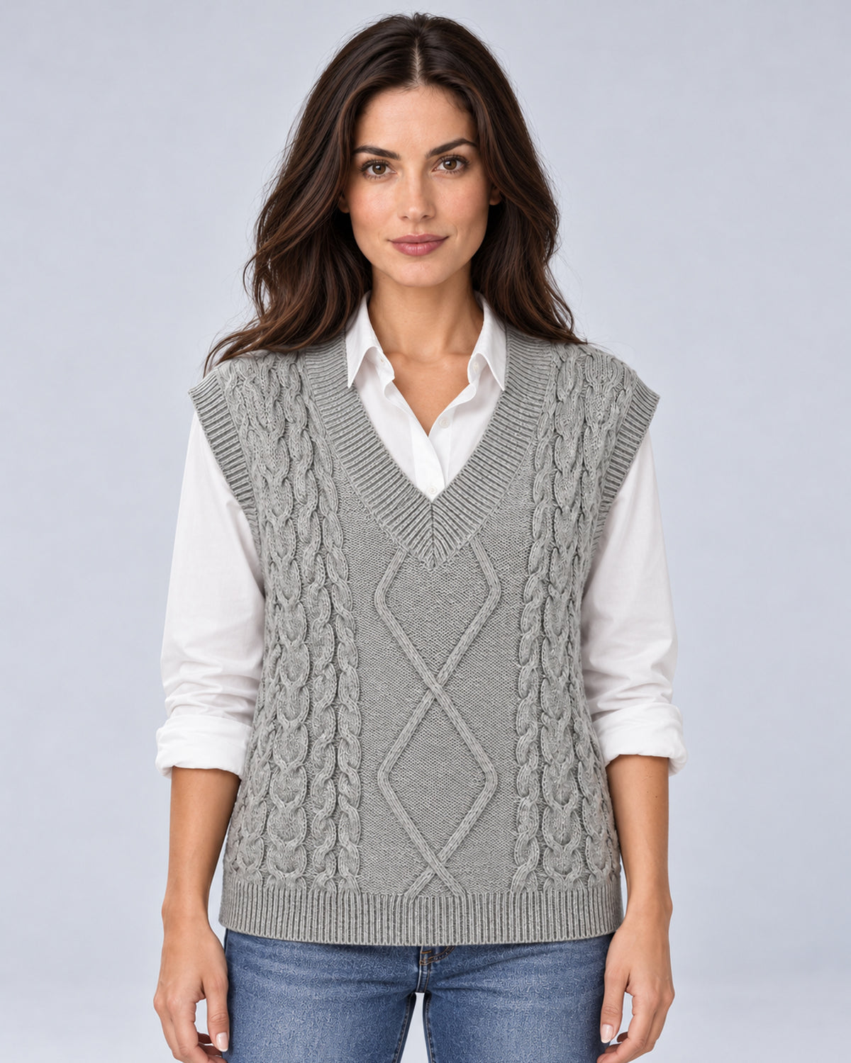 Women's grey cable-knit V-neck sweater vest, front view over a white shirt