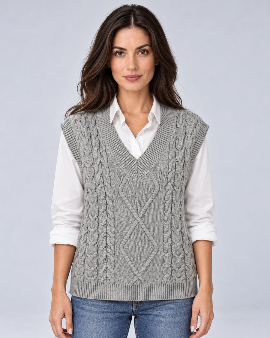 Women's grey cable-knit V-neck sweater vest, front view over a white shirt