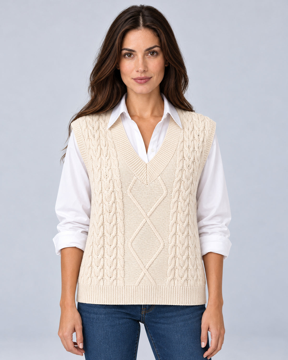 Women's milky cable-knit V-neck sweater vest, front view over a white shirt