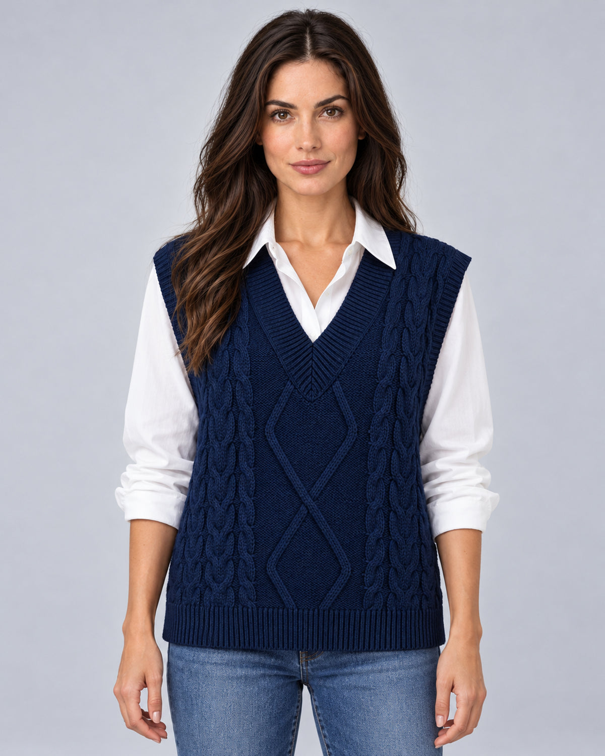 Women's navy blue cable-knit V-neck sweater vest, front view over a white shirt