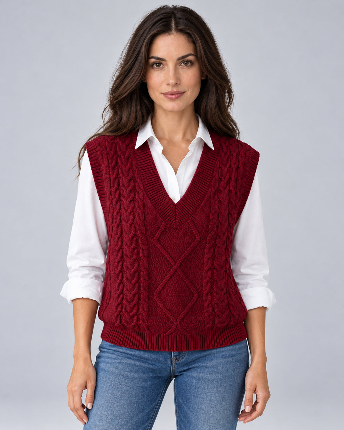 Women's wine red cable-knit V-neck sweater vest, front view over a white shirt