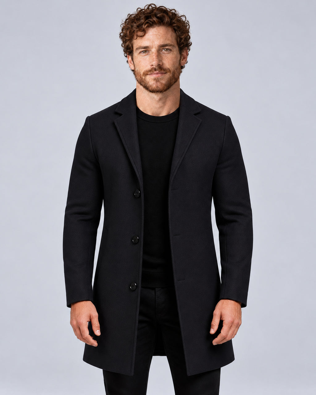 Men’s black tailored overcoat with notch lapels, front view