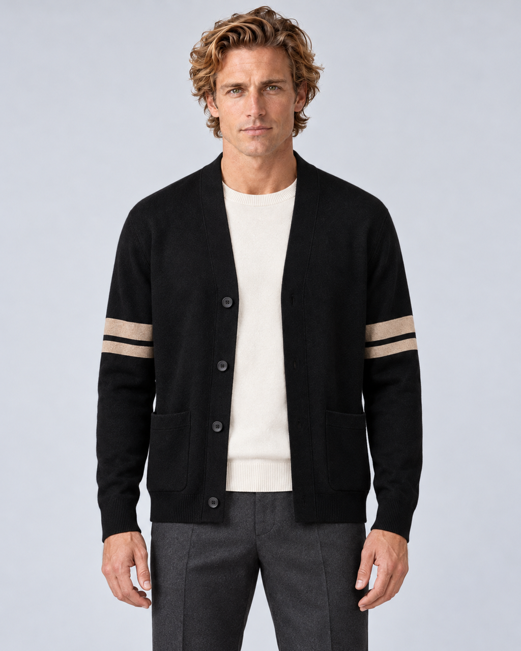 Men's V-neck button-front knit cardigan in black with contrast sleeve stripes, front hero, on a studio model